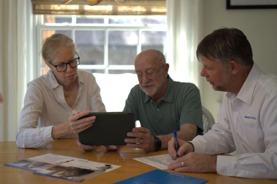A Lifeway Mobility consultant and a couple discussing home accessibility at a table